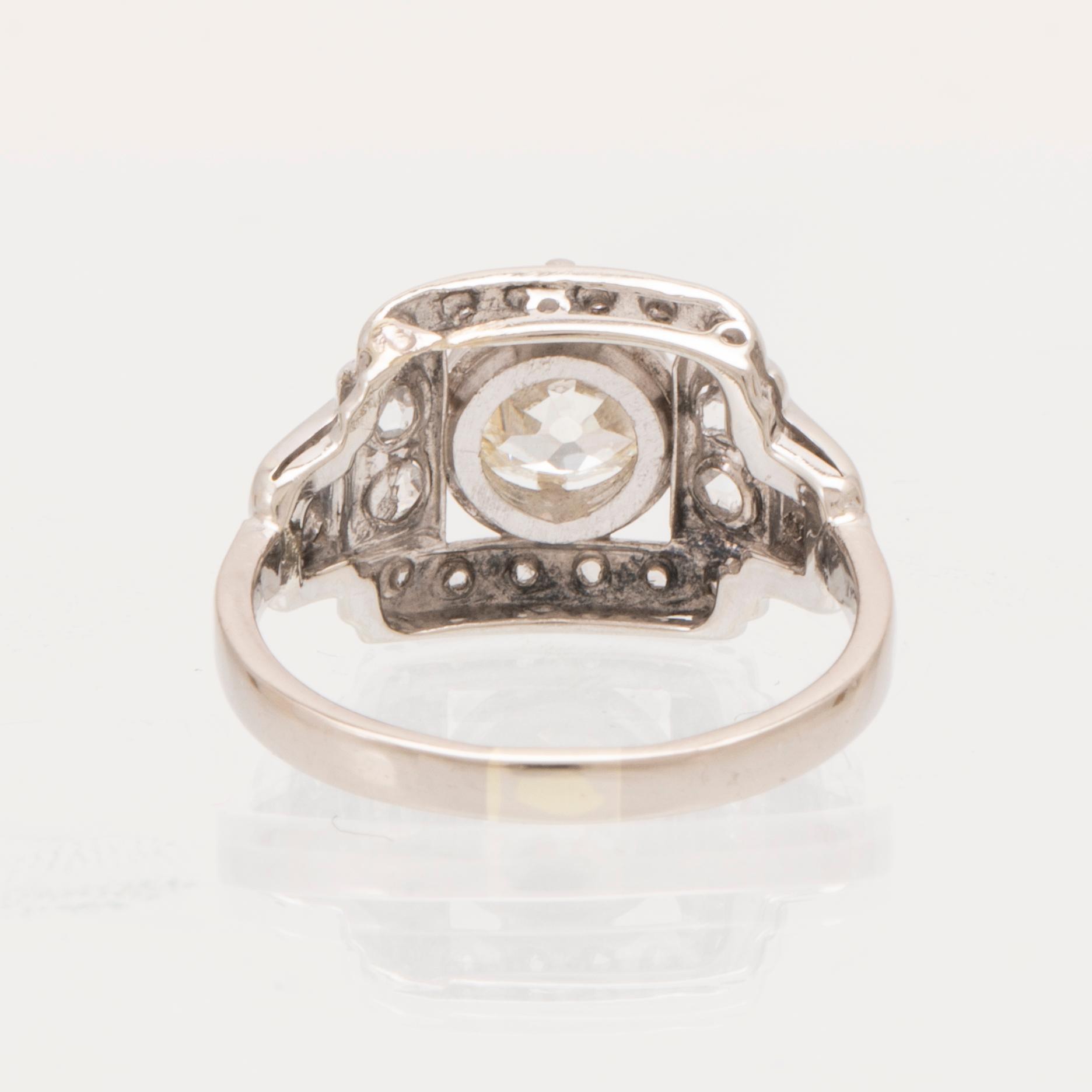 An 18K white gold ring set with an old cut diamond and rose cut diamonds.