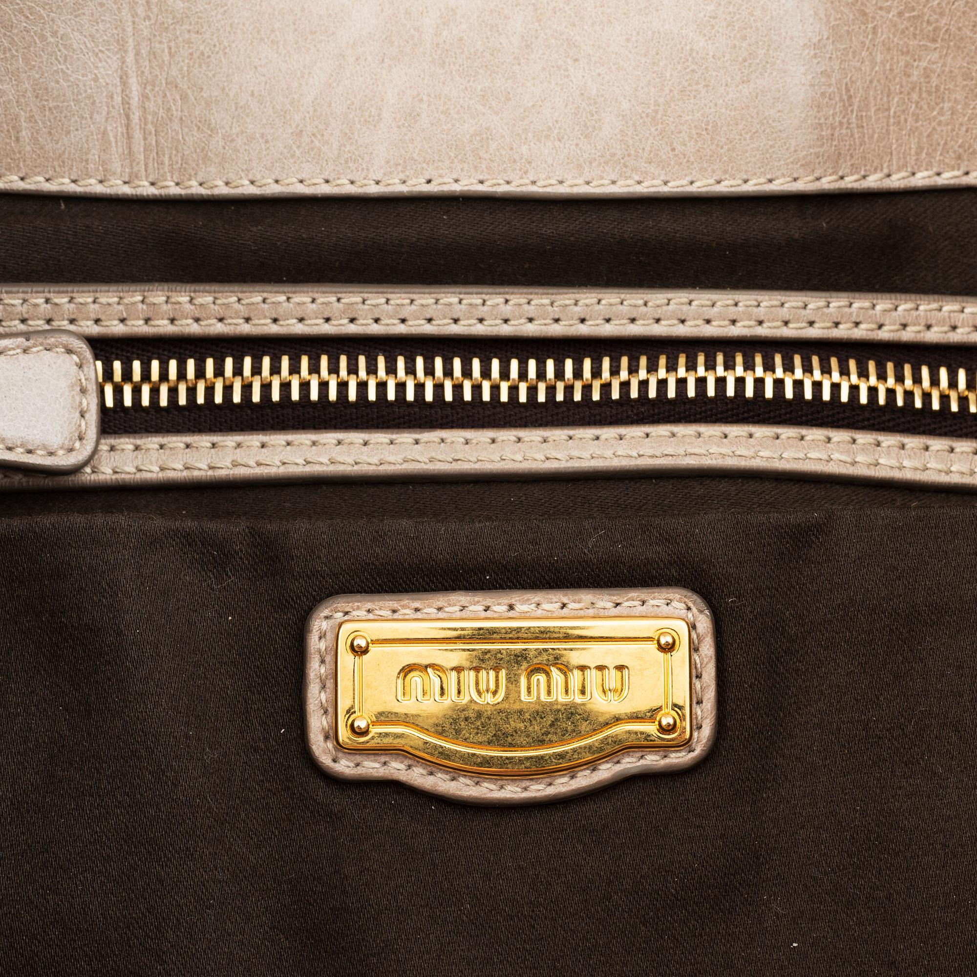 Miu Miu, a light leather handbag.