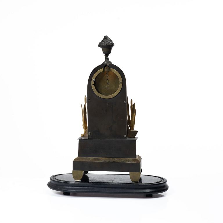 A French Charles X ormolu and patinated bronze mantel clock, ca 1820's.