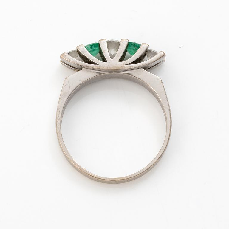 18K white gold ring set with round brilliant-cut diamonds and emeralds.