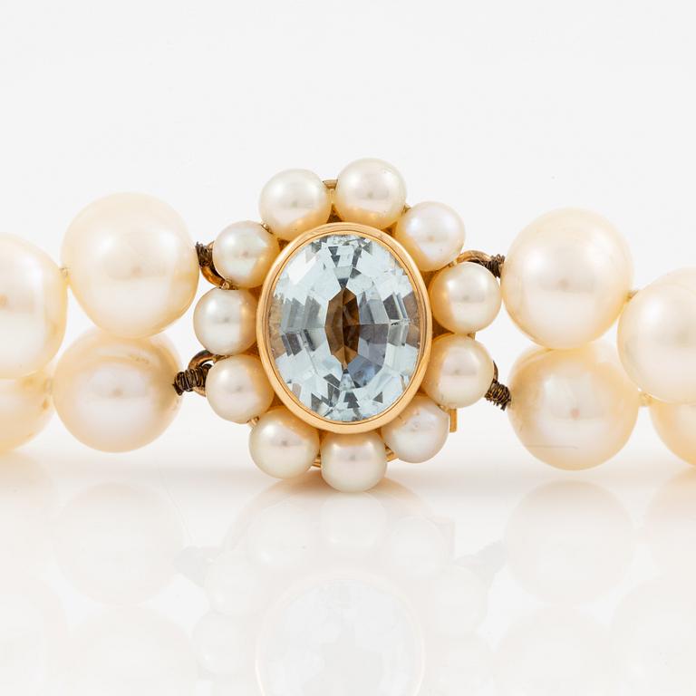 A two strand cultured freshwater pearls necklace, clasp 18K gold with an aquamarine.