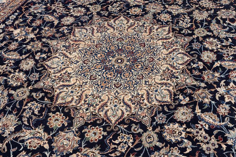 A Nain part silk carpet, c. 535 x 340 cm.