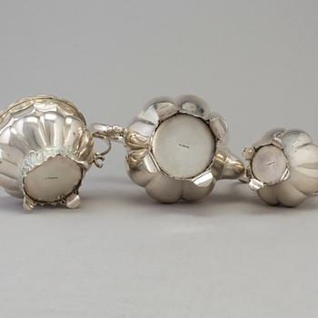A three piece silver coffee set dated 1916-17.