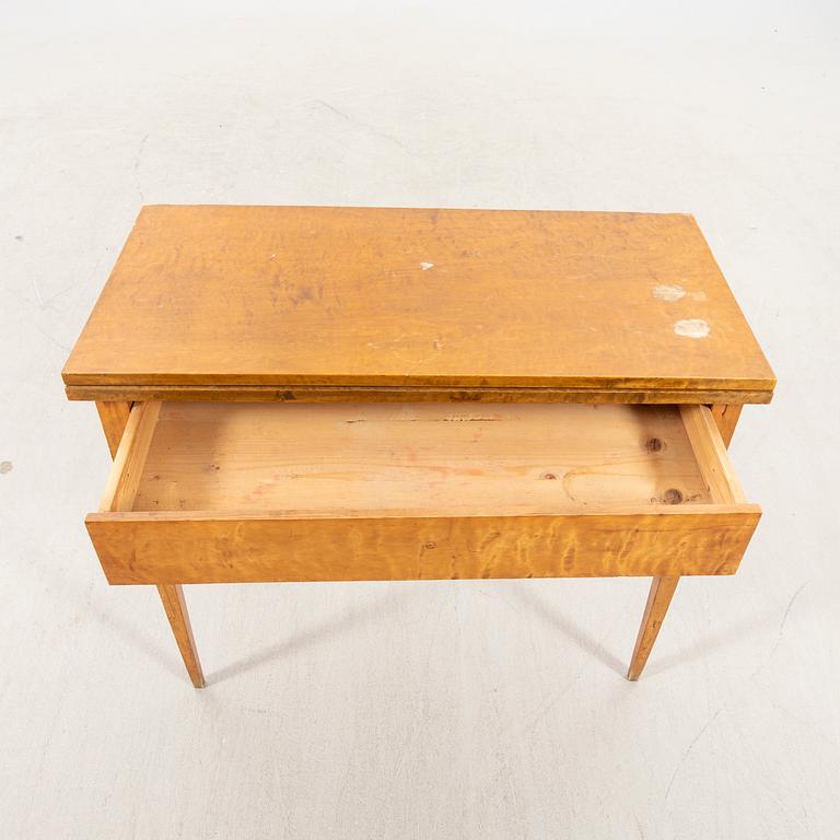 An earluy 1900s birch game table.