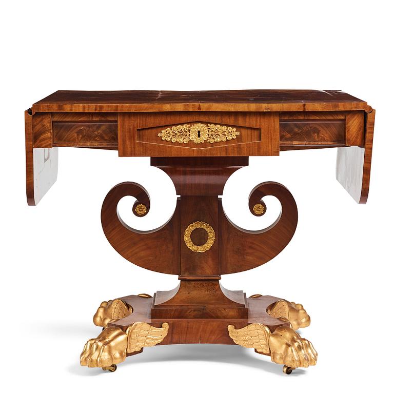 A Swedish Empire mahogany center table by Johan Öman, (Stockhom 1815-1833).