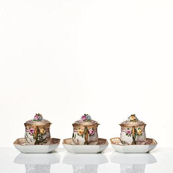 A set of 12 Royal Copenhagen 'Flora Danica' custard cups with covers and stands, Denmark, 20th Century.