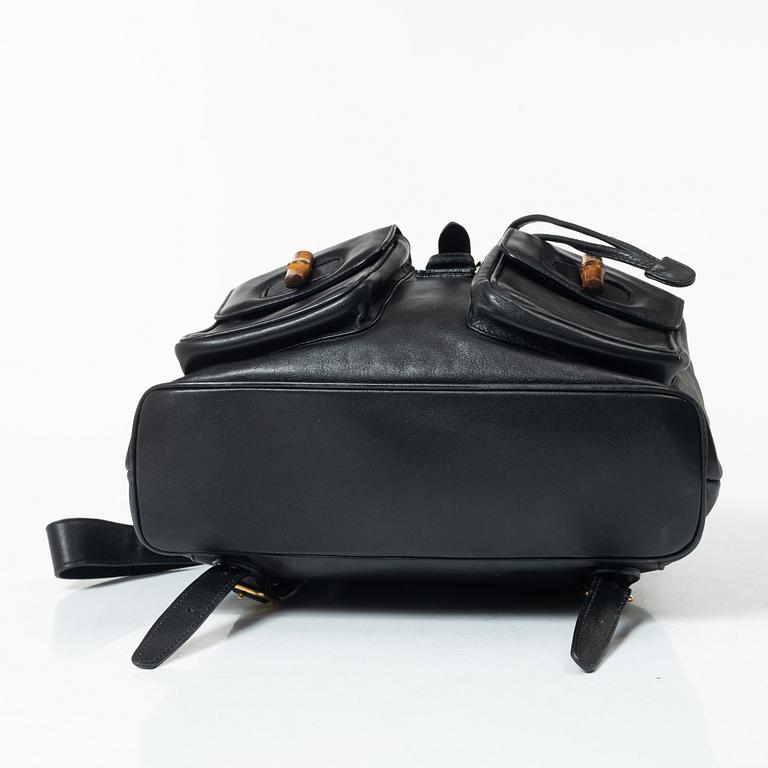 Gucci, A black leather backpack.