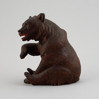 A carved wooden sculpture of a "Black forest bear" from around the year 1900.