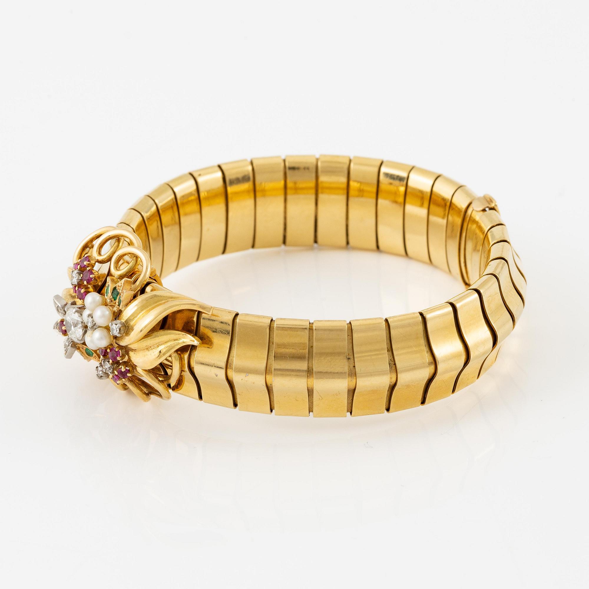 A Strömdahls bracelet/pendant combination in 18K gold with rubies, emeralds, pearls and diamonds.