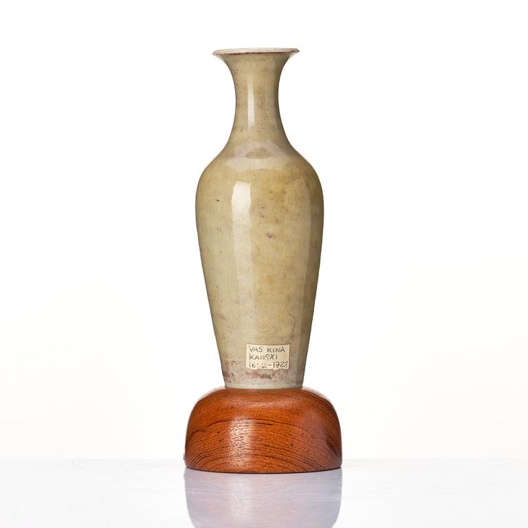 A pale celadon 'peachbloom' glazed vase, Qing dynasty with Kangxi six character mark.