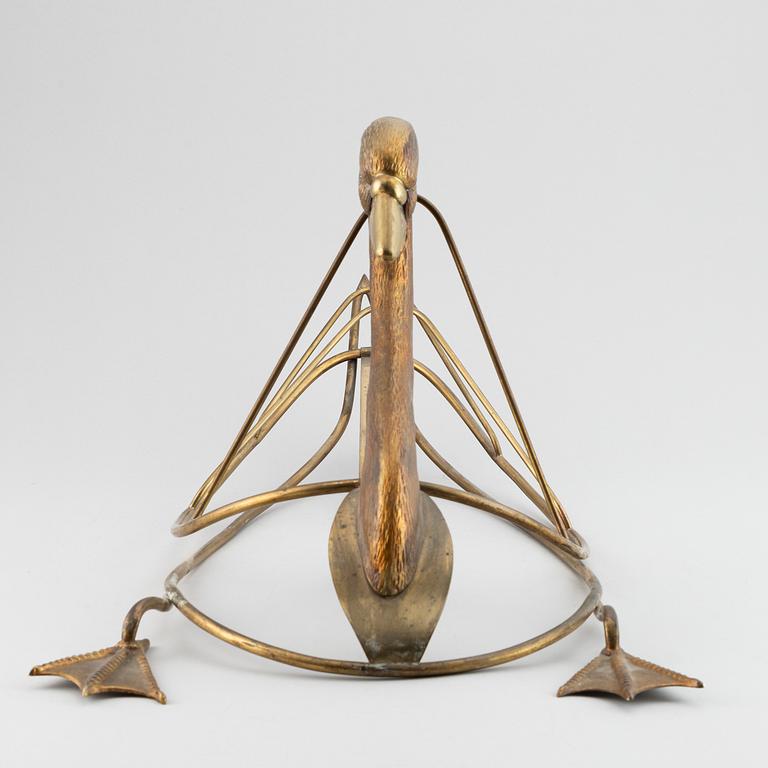 A 20th century grass newspaper stand in the shape of a swan.