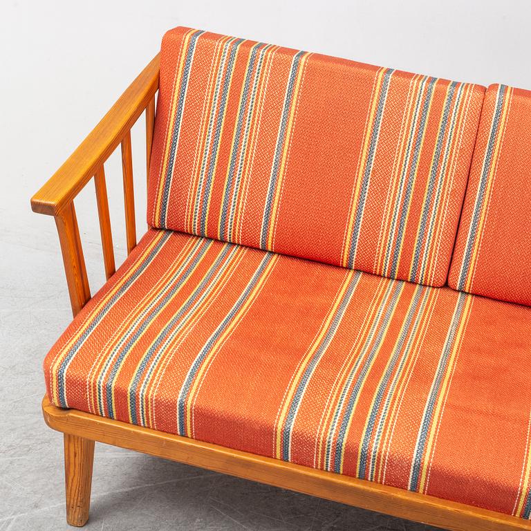 A Swedish 1960s Carl Malmsten pine wood sofa.