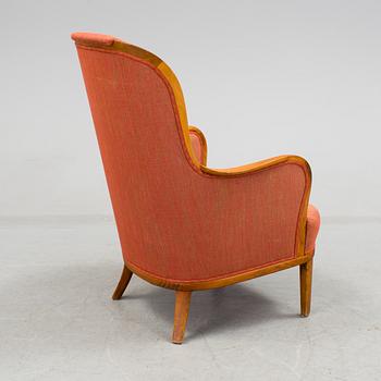 a 20h Century walnut armchair "Advokaten" designed by Carl Malmsten.