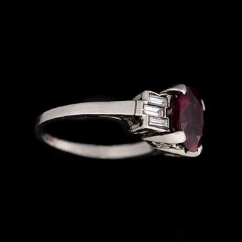 A RING, facetted ruby, baguette cut diamonds, platinum.