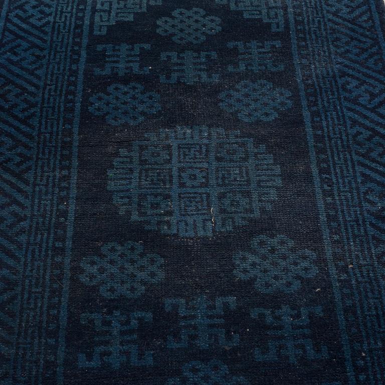 A RUG, a semi-antique Baotou, ca 108 x 54,5 cm.