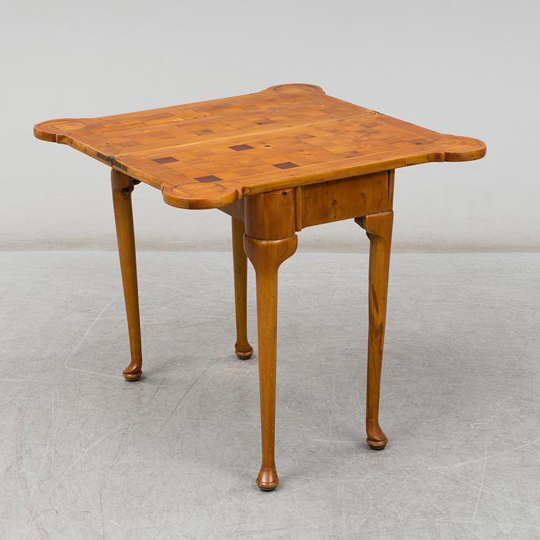 An end of the 19th Century Queen Anne-style card table.