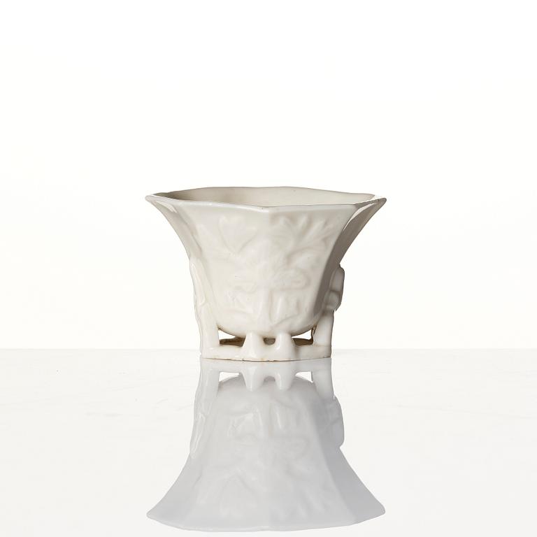 A lacquer tea box and a blanc de chine cup, Qing dynasty 18/19th century.