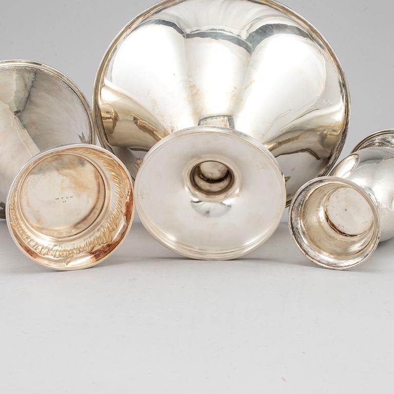 Two silver beakers and a bowl.