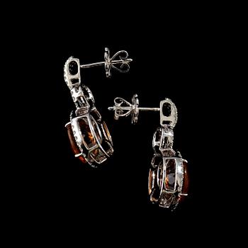 A pair of citrine and diamond earrings.