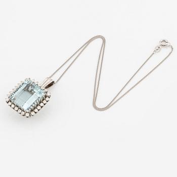 An 18K white gold Engelbert pendant set with a aquamarine and round brilliant-cut diamonds.