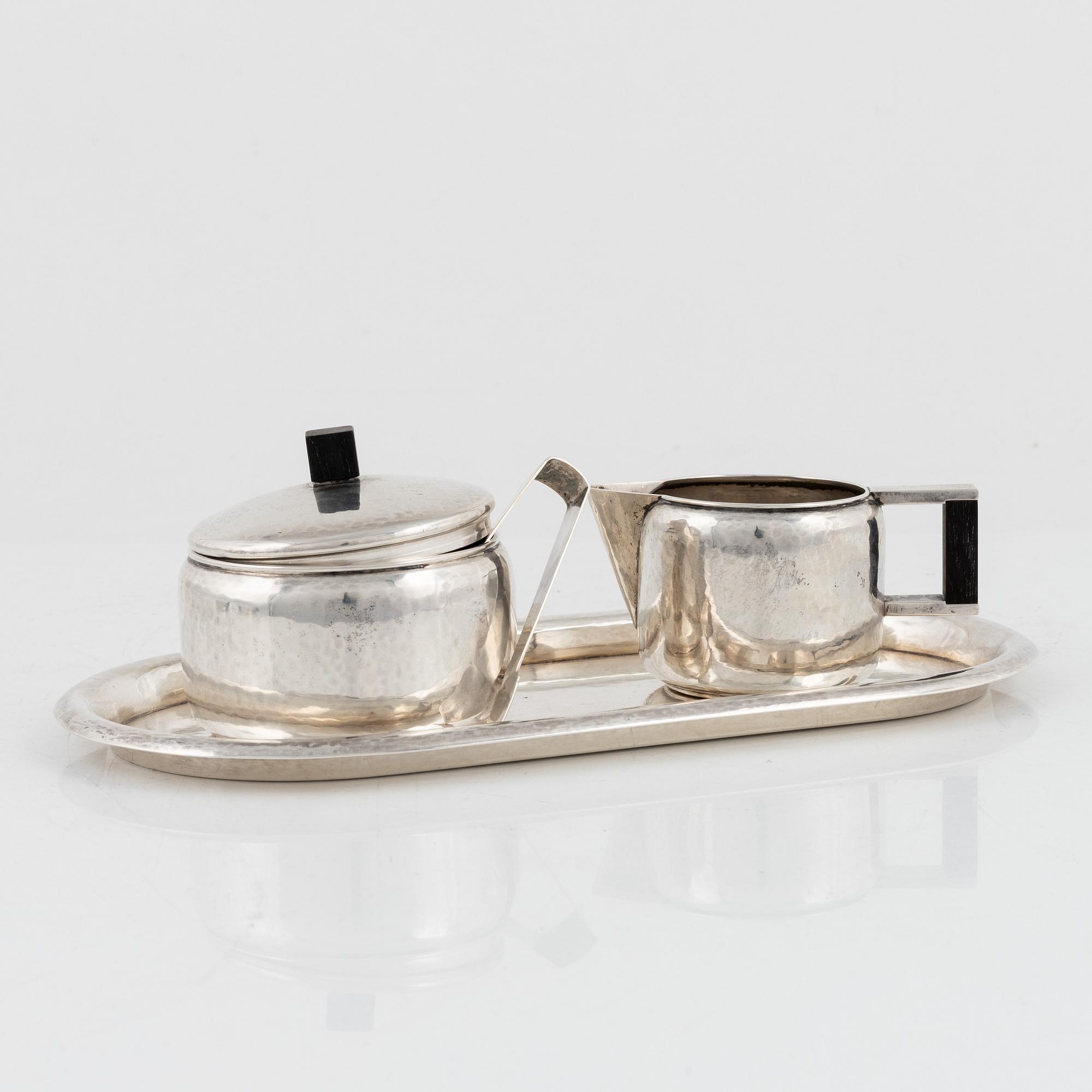 A 4-piece German silver coffee service and two German glass and silver plated tea cups, 1930's.
