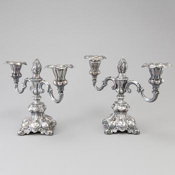 A pair of Swedish Rococo style silver candelabras from C G Hallberg in Stockholm 1955 and 1959.