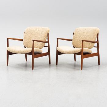 A pair of model FD 136 easy chairs with new sheepskin upholstery by Finn Juhl for France & Son, designed 1958.