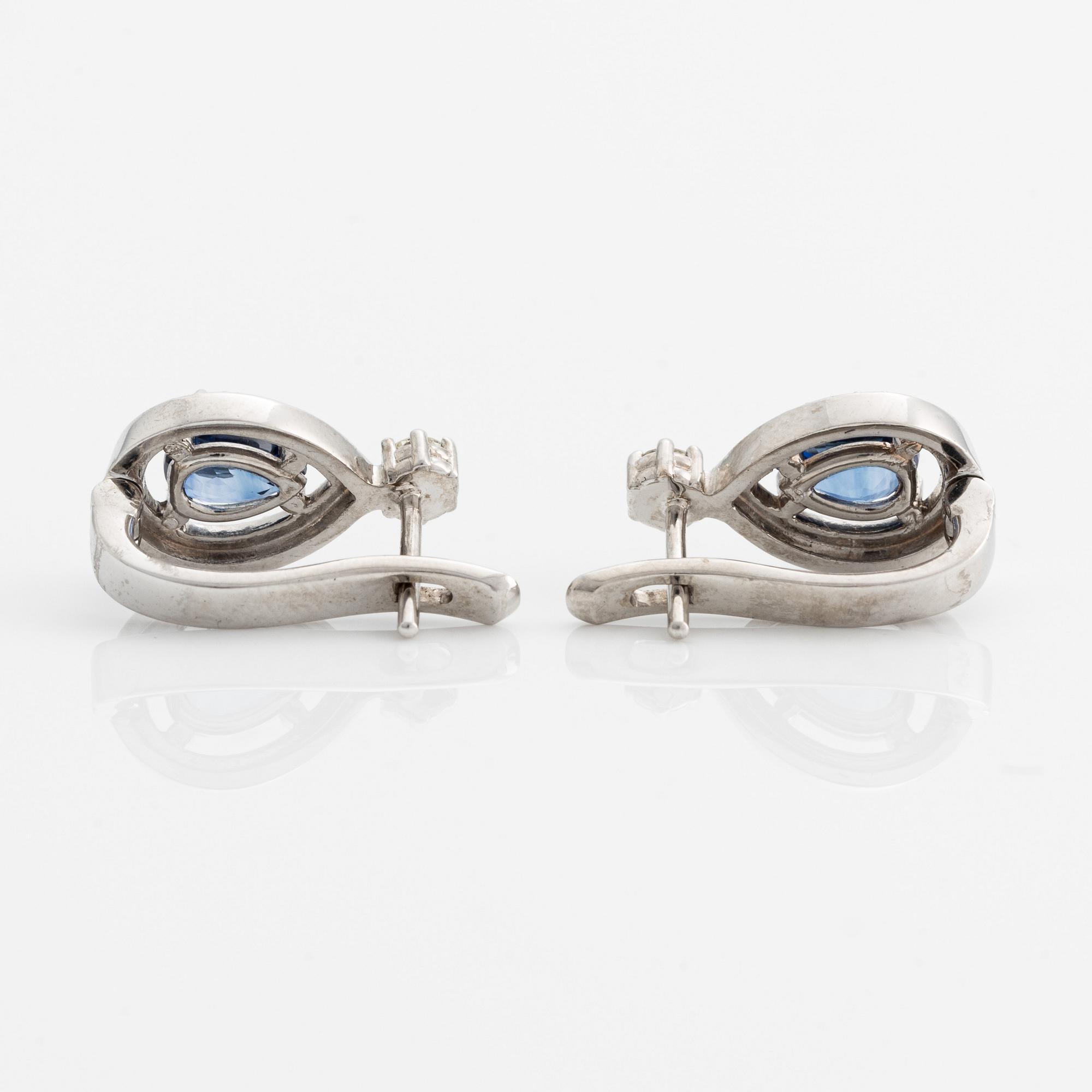 A pair of 14K gold earrings with faceted sapphires and round brilliant-cut diamonds.