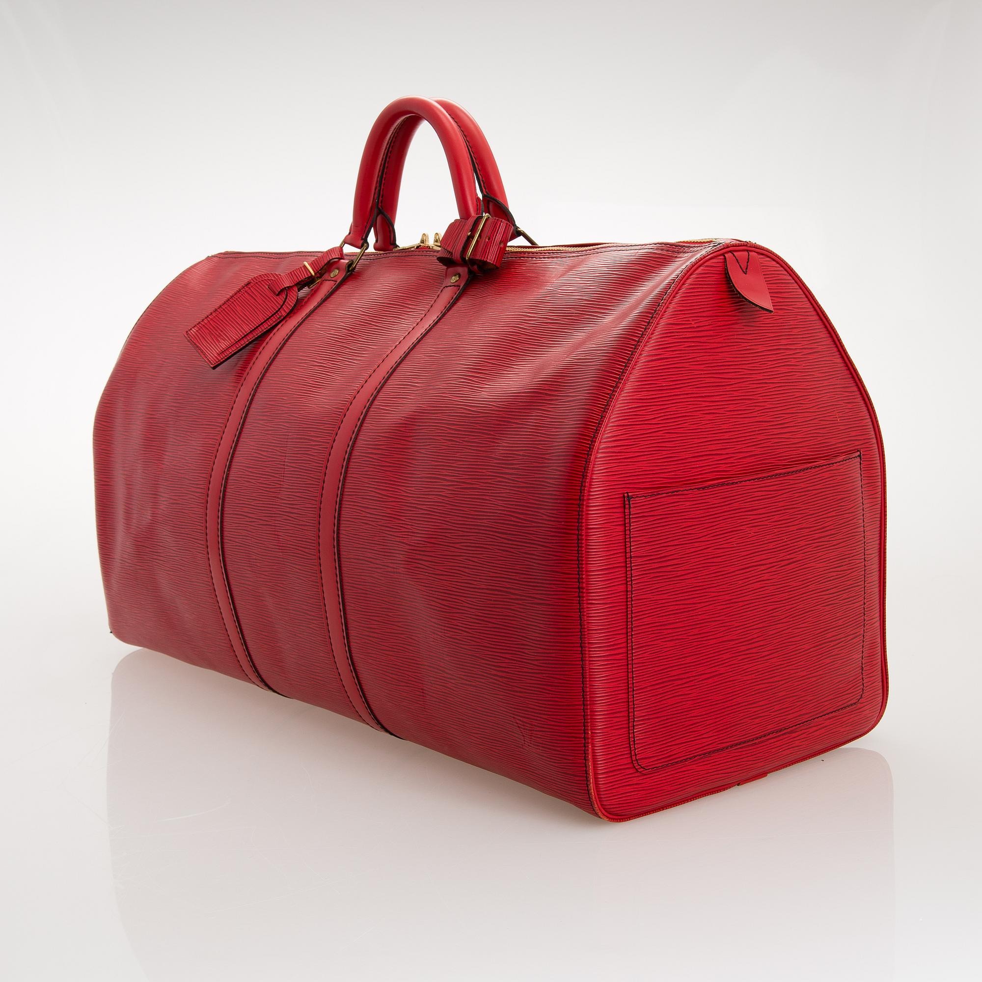 A RED EPI LEATHER KEEPALL TRAVEL BAG.