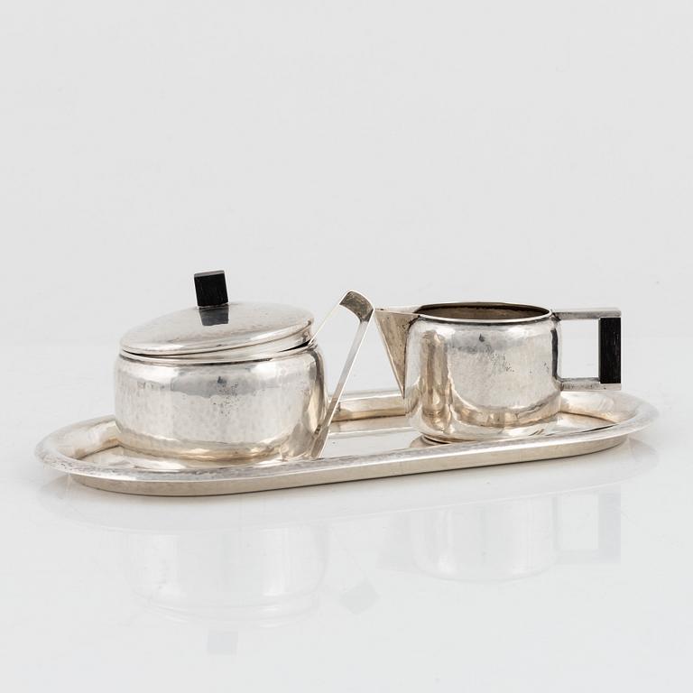 A 4-piece German silver coffee service and two German glass and silver plated tea cups, 1930's.
