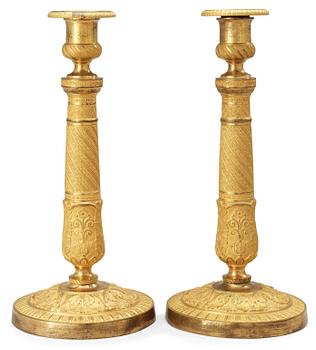 685. A pair of French Empire early 19th Century candlesticks.