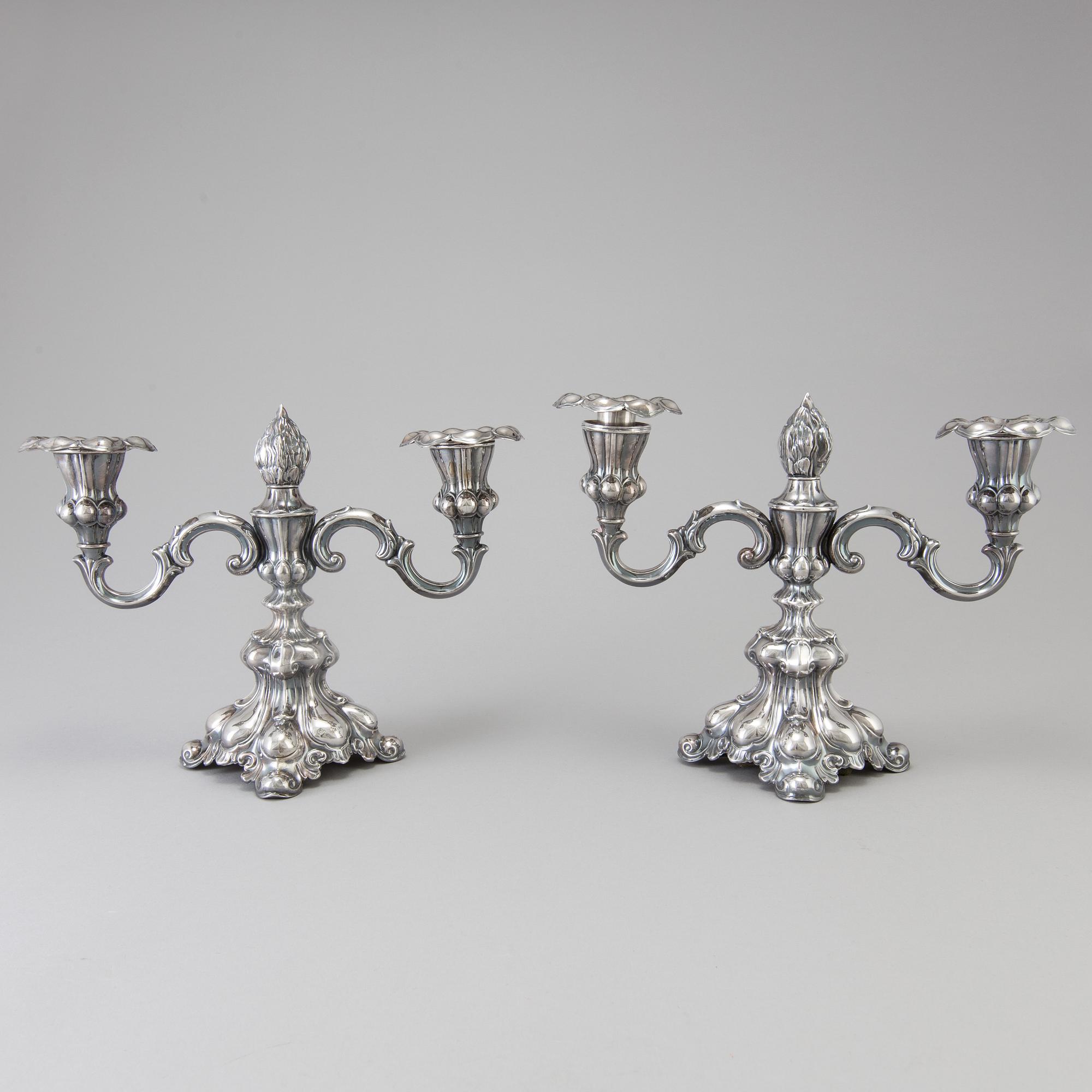 A pair of Swedish Rococo style silver candelabras from C G Hallberg in Stockholm 1955 and 1959.