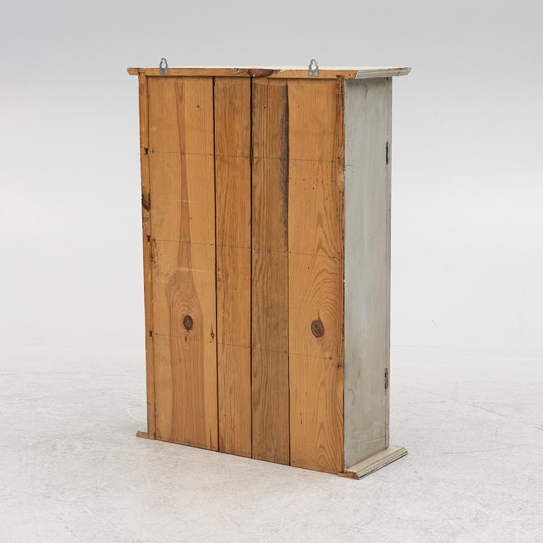 A wall cabinet, around 1900.