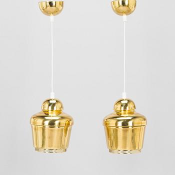 Alvar Aalto, A pair of  A 330, 'Golden Bell' pendant lights A330 for Artek, 2000s.