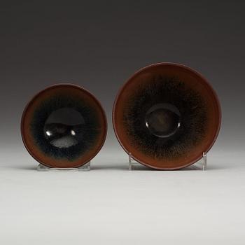 Two temmoku tea bowls, with 'hare's fur' glaze, the glaze pooling short of the unglazed feet. Song dynasty (960-1279).
