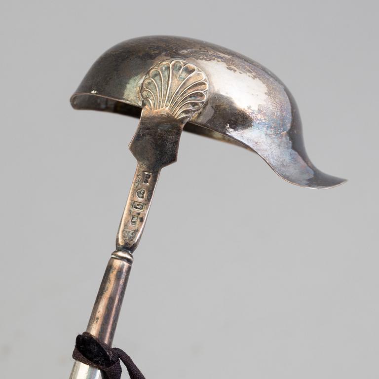 A 19th century silver soup and a sauce ladle with wooden handles.