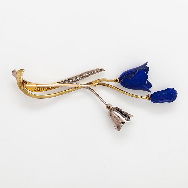 Raimo Nieminen, Brosch "Valonkukka", 18K gult. grönt och vitt guld, diamanter ca 1.40 cy och skuren lapis lazuli. 2005.