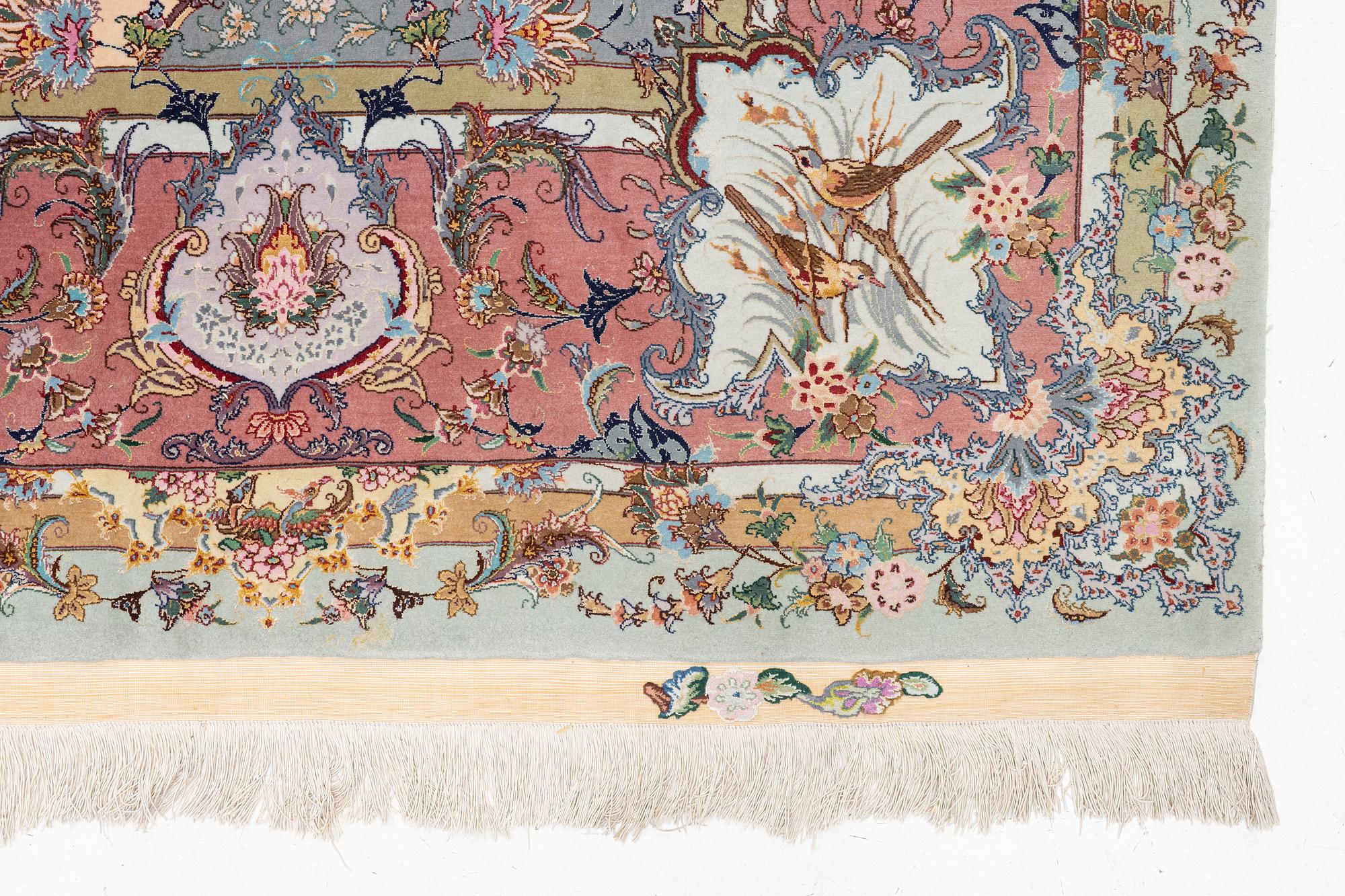 A Tabriz carpet, part silk, approx. 367 x 250 cm.
