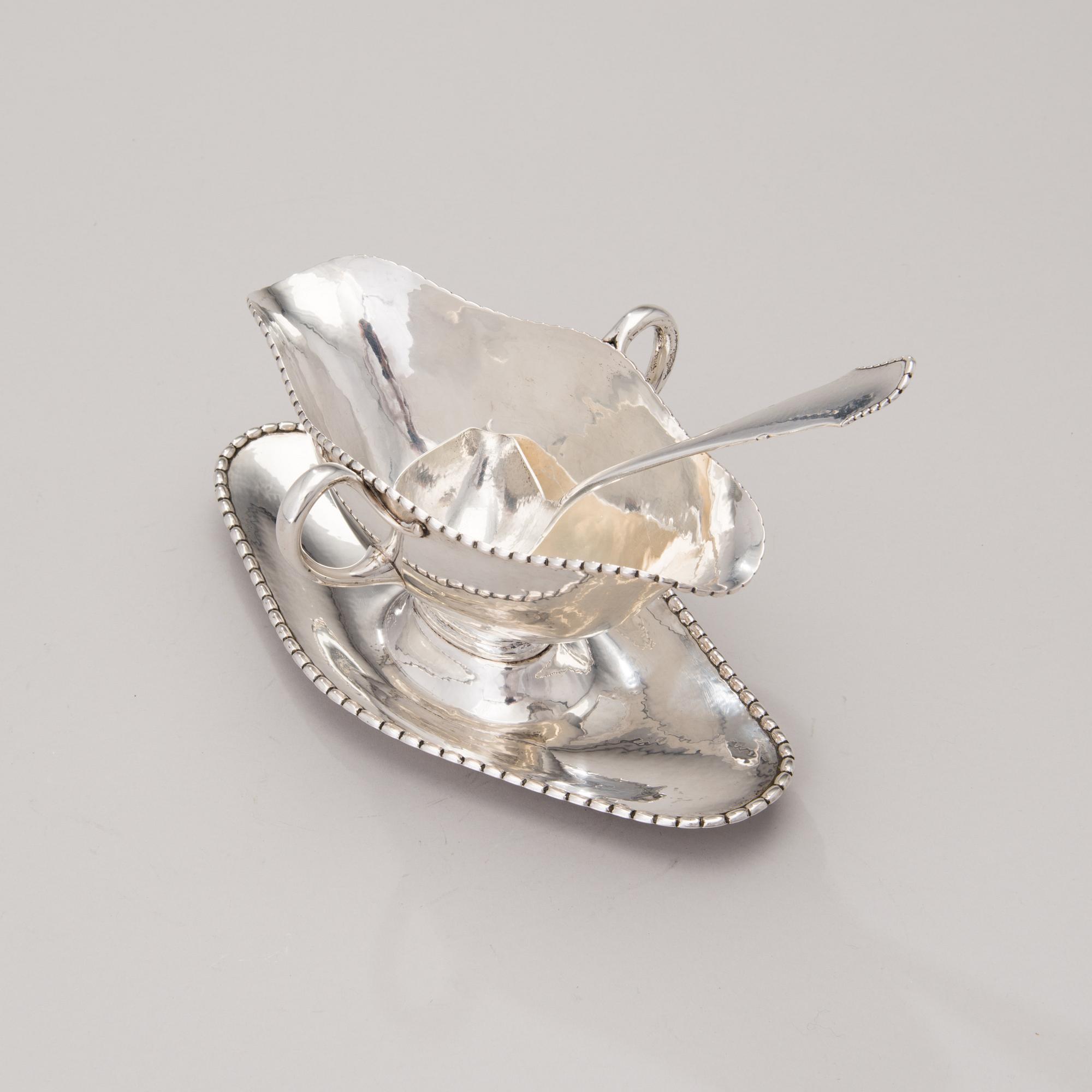 A sauce boat with a sauce ladle in silver, mark of Paul Bang, Copenhagen, Denmark 1929 and 1930s.