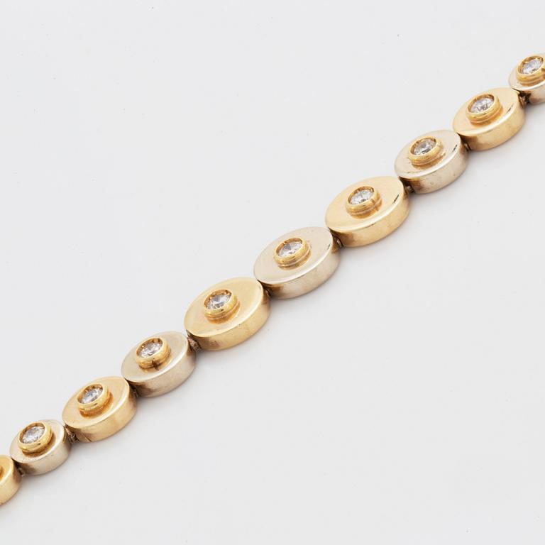 A 14K gold bracelet set with round brilliant-cut diamonds.