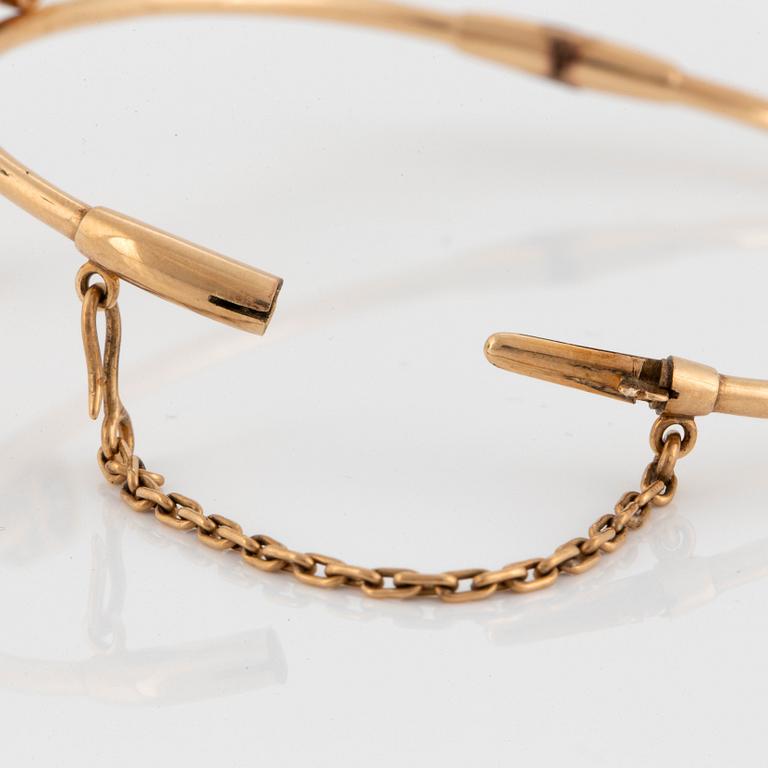 A 14K gold bangle set with old- and rose-cut diamonds.