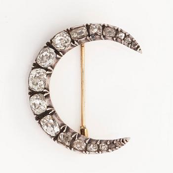 A late 19th century crescent brooch, 14K gold/silver, with old-cut diamonds totalling approximately 1.24 ct.