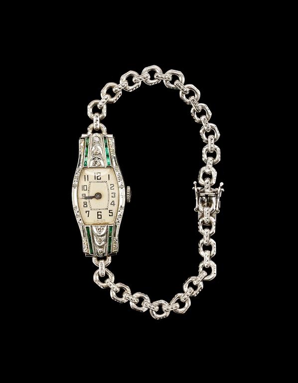 DAMARMBANDSUR, 18k vitguld med smådiamanter och smaragder, Malmö, 1953.
