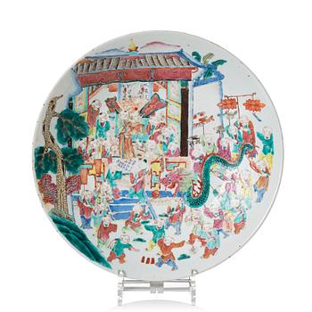 A famille rose dish decorated with a dragon festival moment, Qing dynasty, 19th Century.
