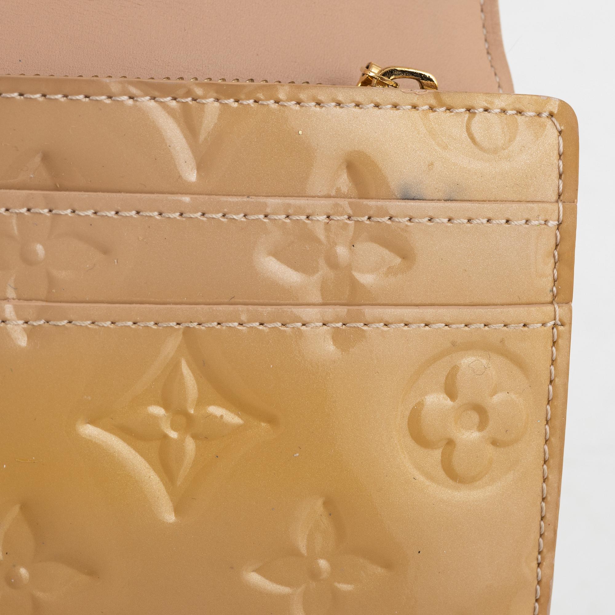 Louis Vuitton, a 'Sarah' vernis wallet.