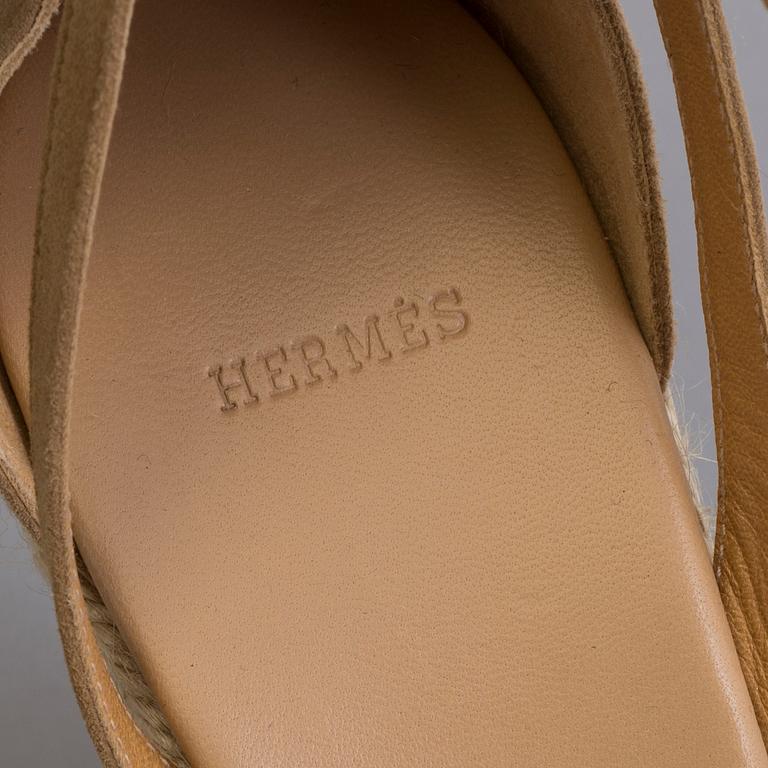 A beige suede platform sandals by Hermès.