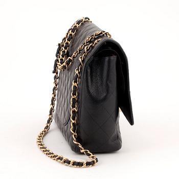 CHANEL, a black caviar leather shoulder bag, "Double Flap Maxi".