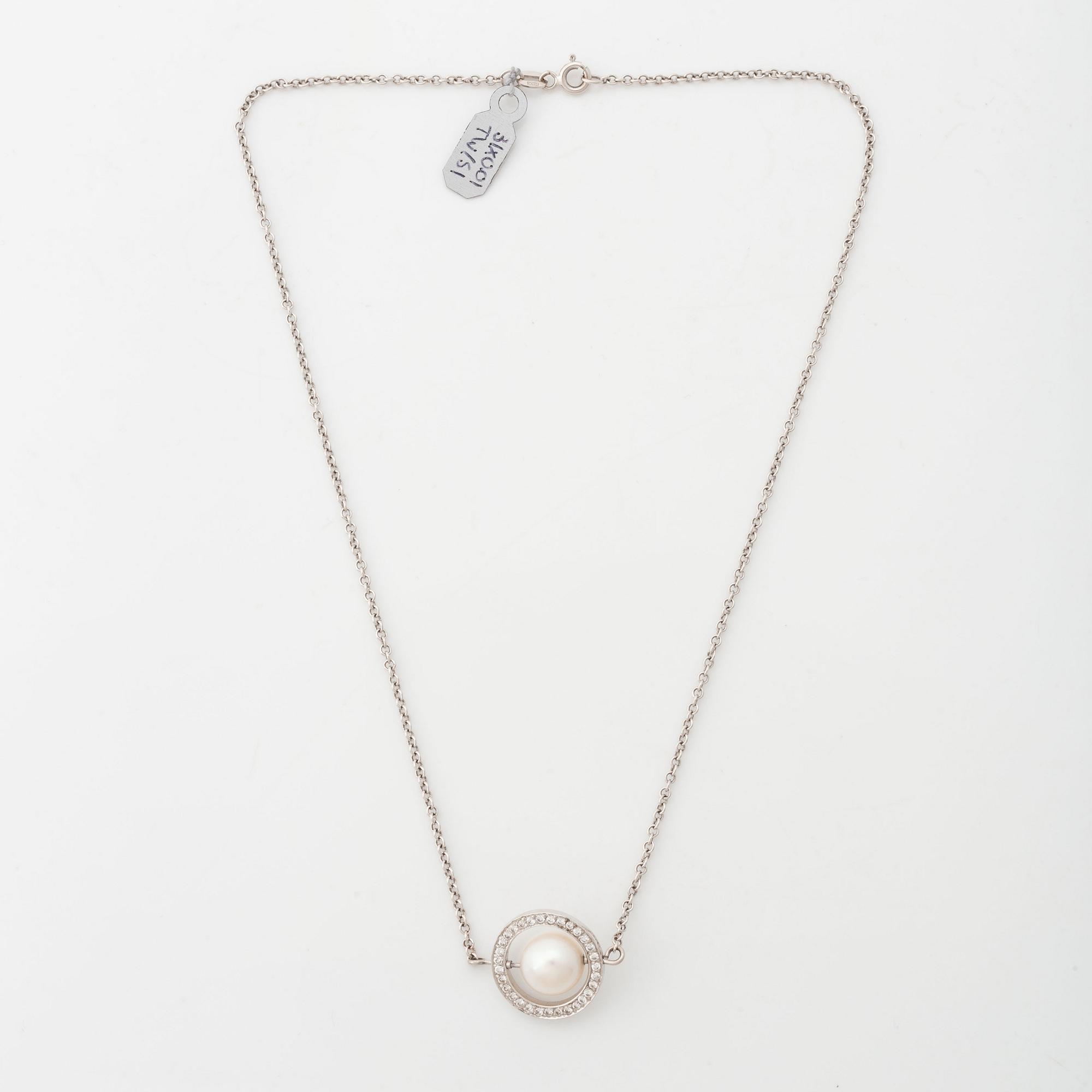 18K white gold, cultured pearl and brilliant cut diamond necklace.