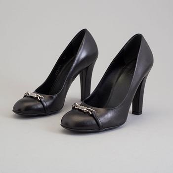 A pair of black pumps by Gucci.