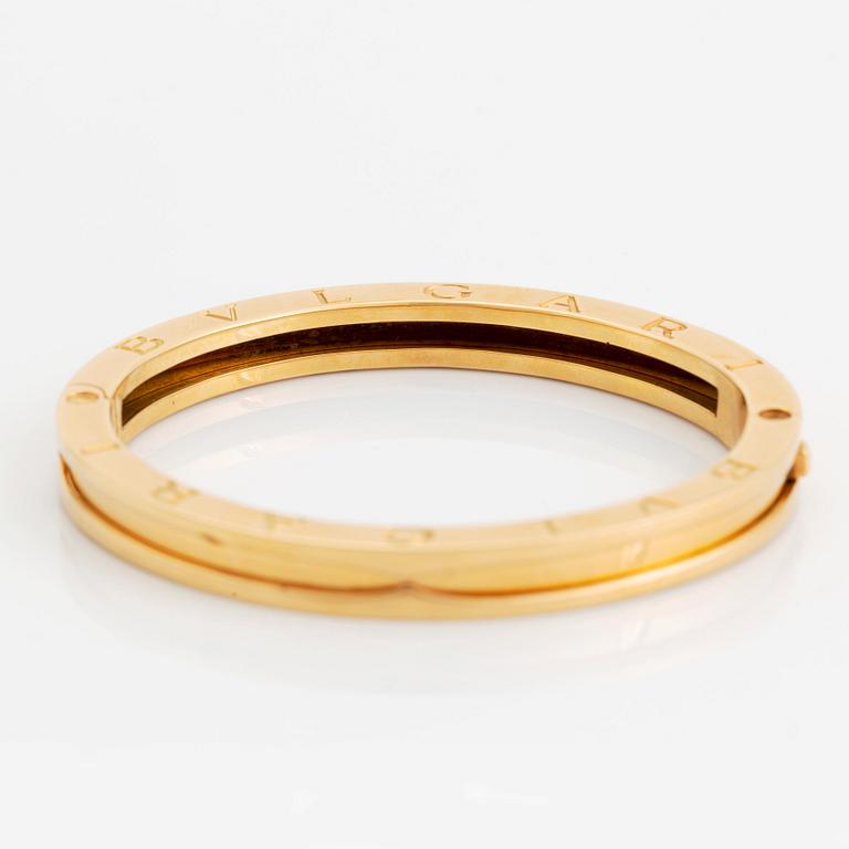 An 18K gold Bulgari bangle.